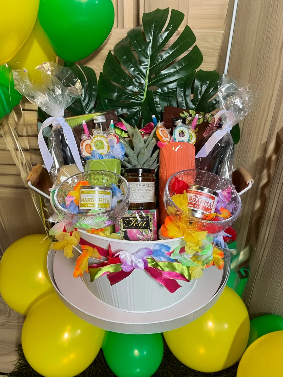 Gift set tower of snacks and keepsakes with bright ribbons and green and yellow balloons