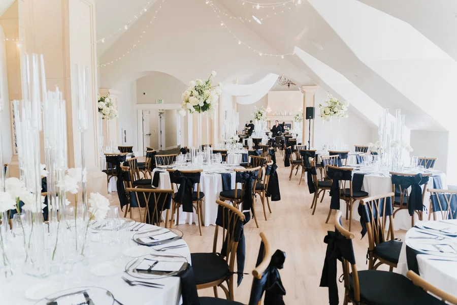 Reception hall with set tables, chairs and a vaulted ceiling